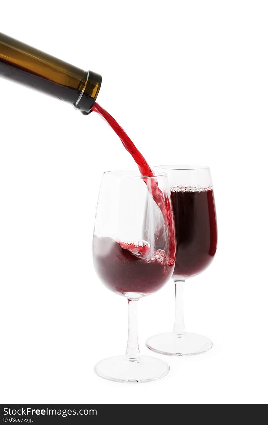 Red wine being poured into one of two glasses. Isolated on white, clipping path included. Red wine being poured into one of two glasses. Isolated on white, clipping path included.