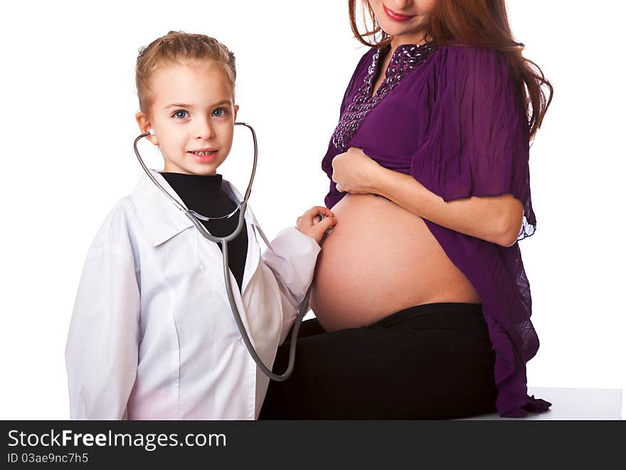 A cute girl is listening to her mother's belly. isolated on a white background