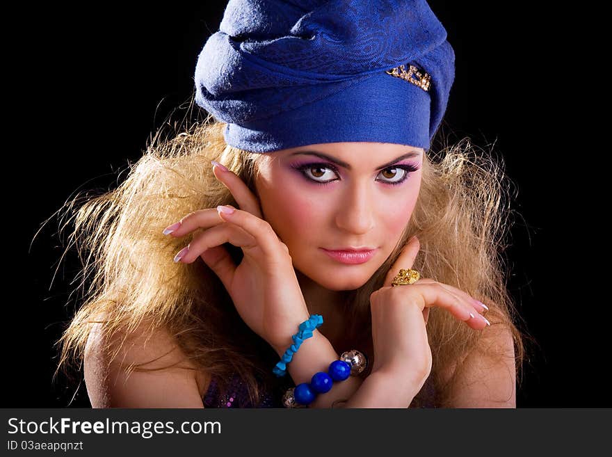 Beautiful girl in a turban and a stylized ethnic costume