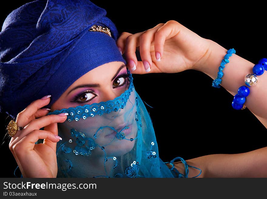 Beautiful girl in the stylized ethnic turban and veil