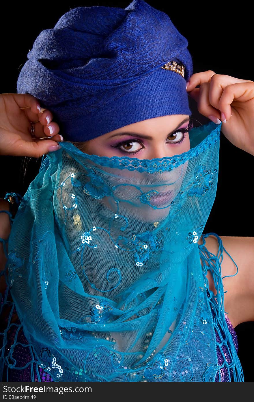 Beautiful girl in the stylized ethnic turban and veil