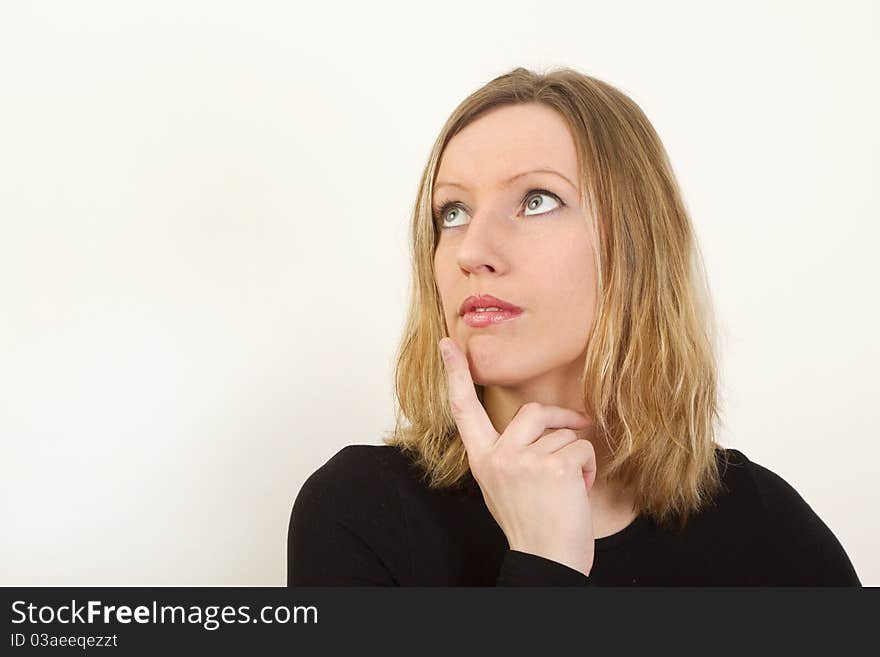 Portrait Of Young Woman Thinking And Looking Up