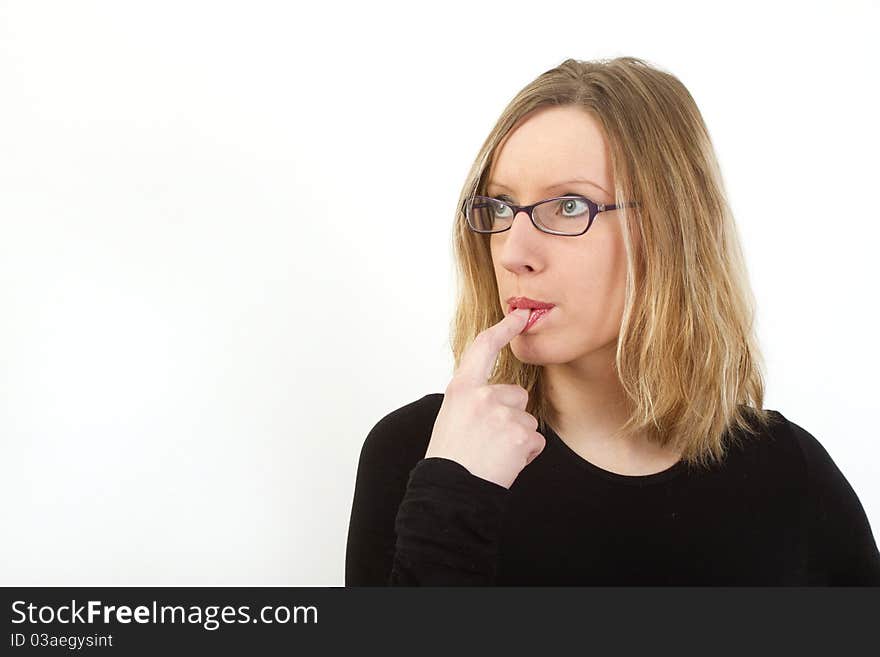 Young woman with glasses have finger in her mouth, looking somewhere and thinking, lots of copyspace