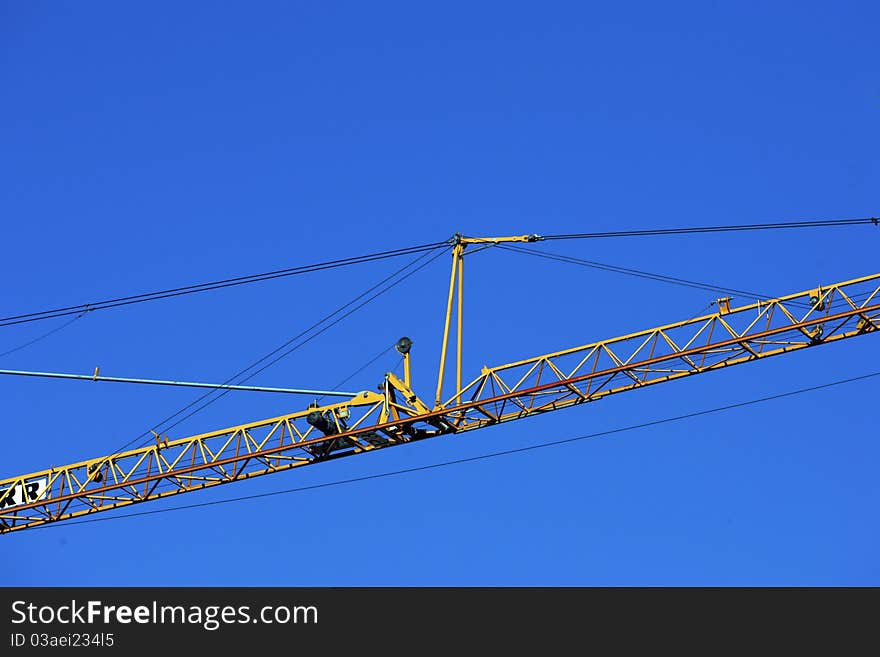 Crane holding a prefabricated element against a limpid sky. Crane holding a prefabricated element against a limpid sky