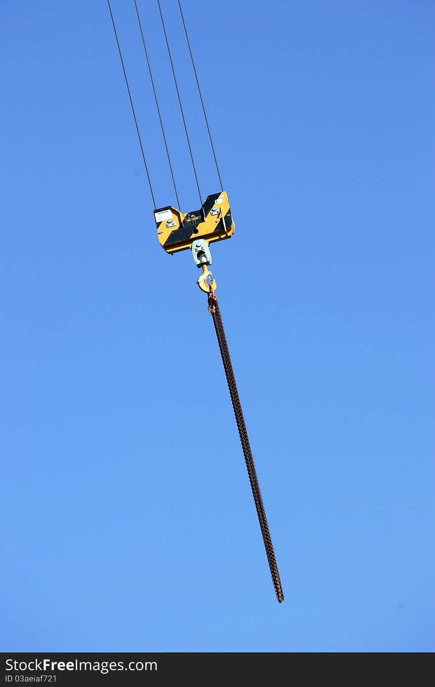 Crane holding a prefabricated element against a limpid sky. Crane holding a prefabricated element against a limpid sky