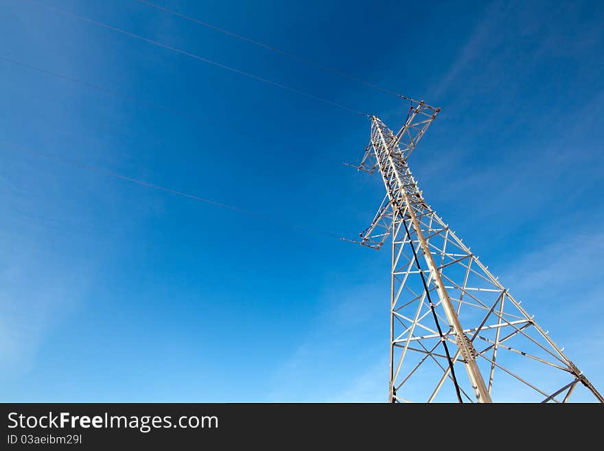 Hight voltage electrical tower against blue sky