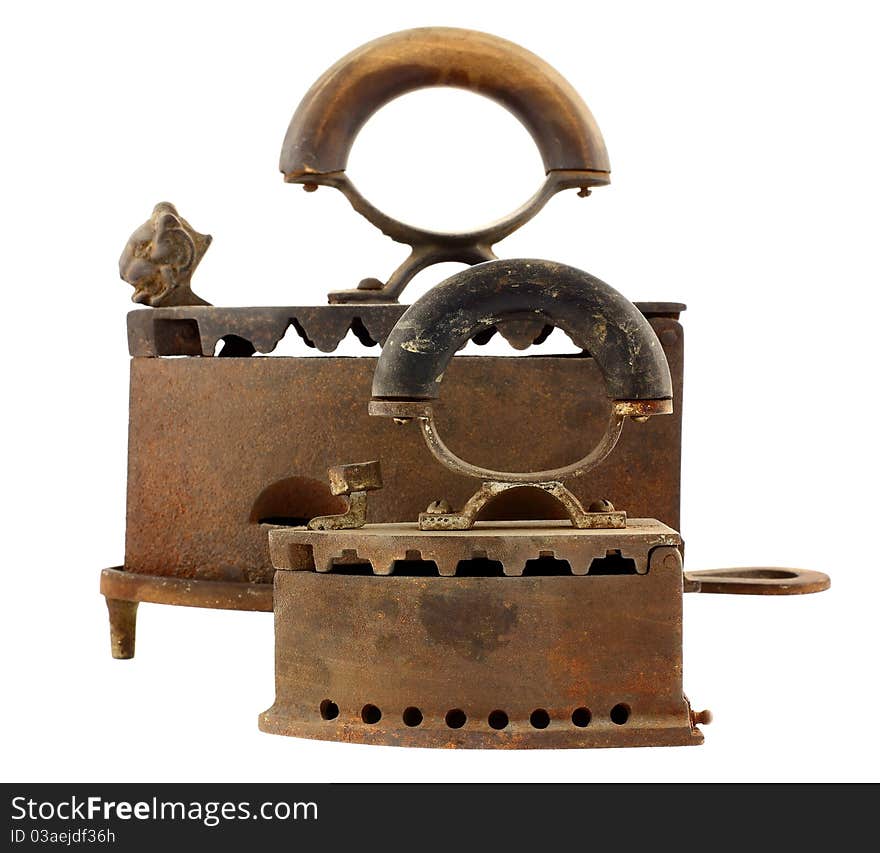 Old irons isolated on white background. Focus on foreground. Intentional shallow depth of field. Studio work.