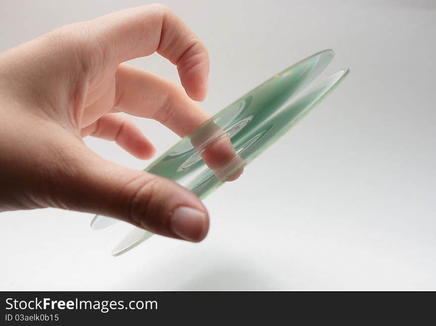 A youthful hand holding a pair of cd's. A youthful hand holding a pair of cd's.