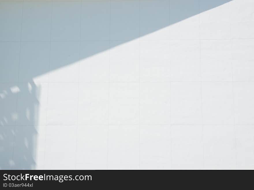 White wall with shadow creating a border at top and left. White wall with shadow creating a border at top and left.