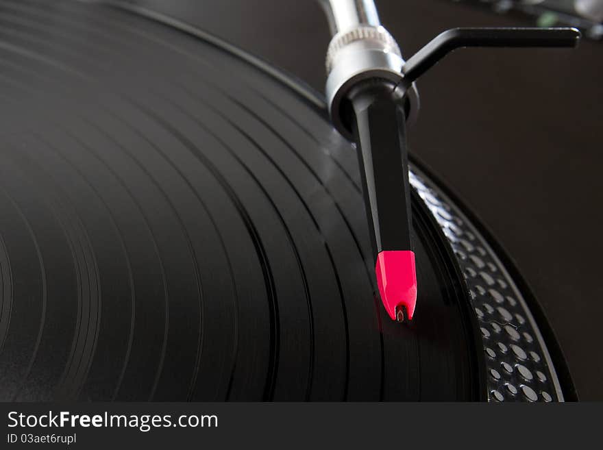 Turntable playing vinyl record with music