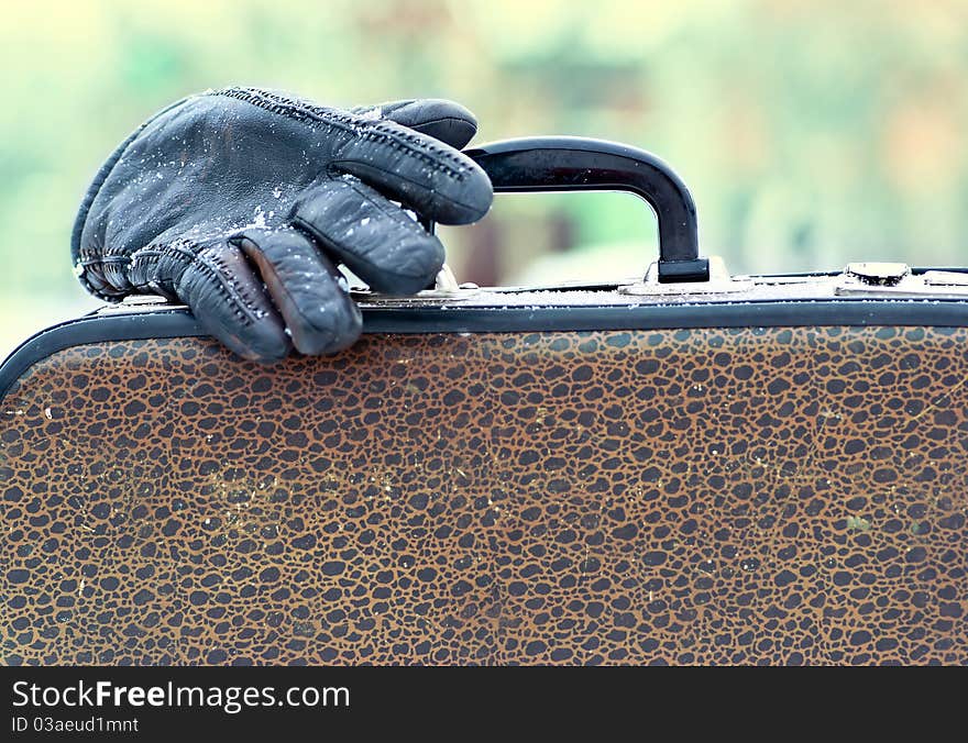 Old suitcase and glove