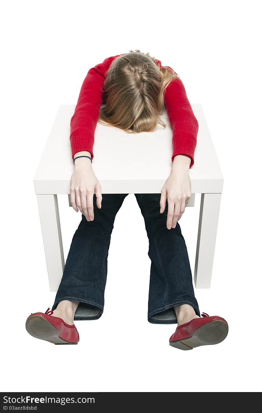 Young woman sleeping at funny small desk