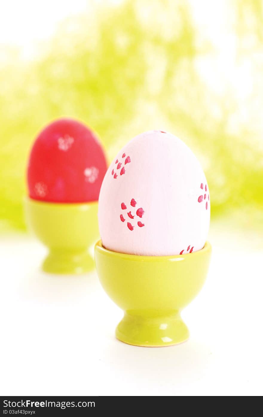 Two egg cups with easter eggs