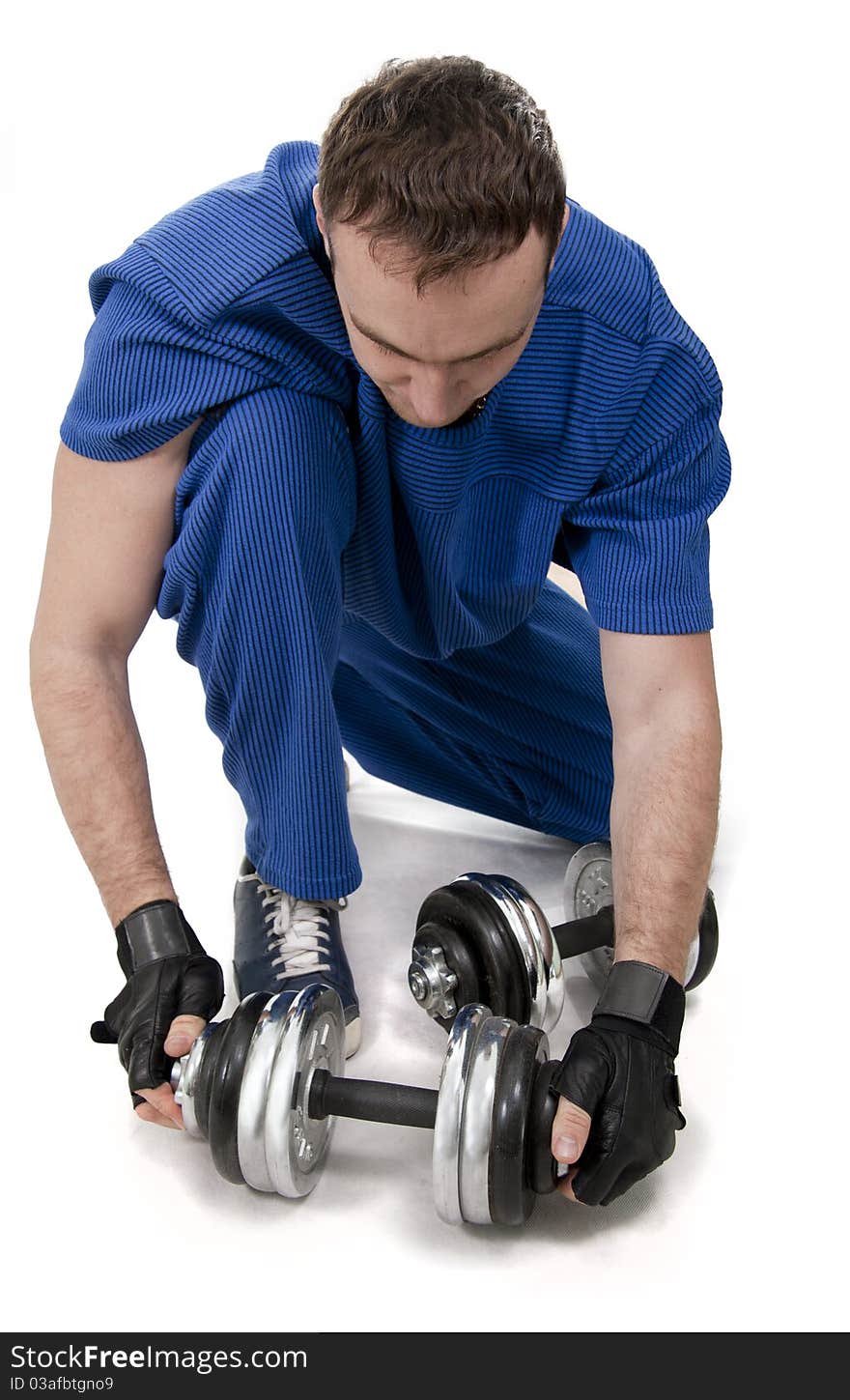 Healthy muscular bodybuilder exercising with dumbbells. White isolated. Healthy muscular bodybuilder exercising with dumbbells. White isolated.