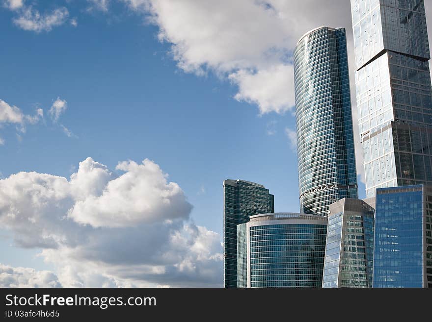 Many scyscrapers of Moscow city under blue sky with clouds