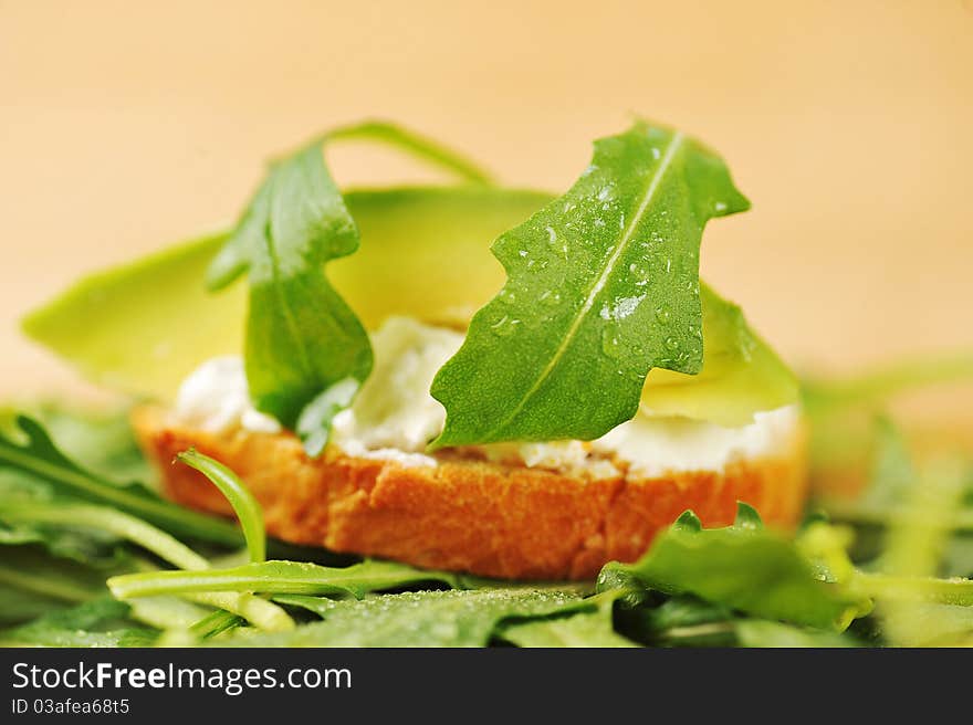 Delicious sandwich of toasted bread, avocado and spinach