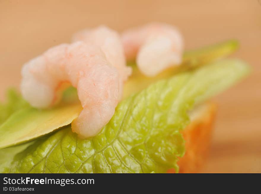 Sandwich garnish with shrimps, avokado and lettuce on bamboo napkin, snack. Sandwich garnish with shrimps, avokado and lettuce on bamboo napkin, snack