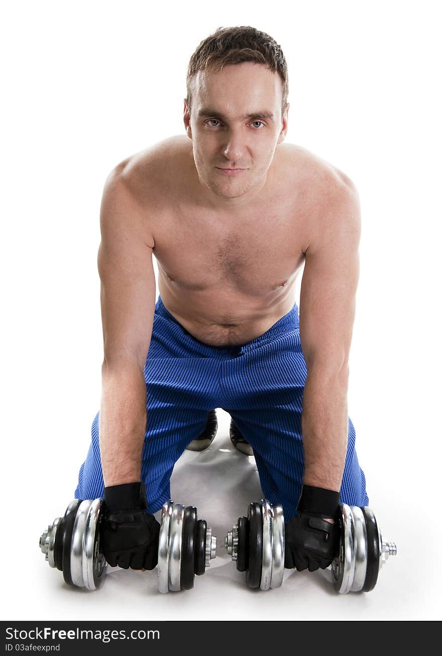 Healthy muscular bodybuilder exercising with dumbbells.White isolated. Healthy muscular bodybuilder exercising with dumbbells.White isolated.