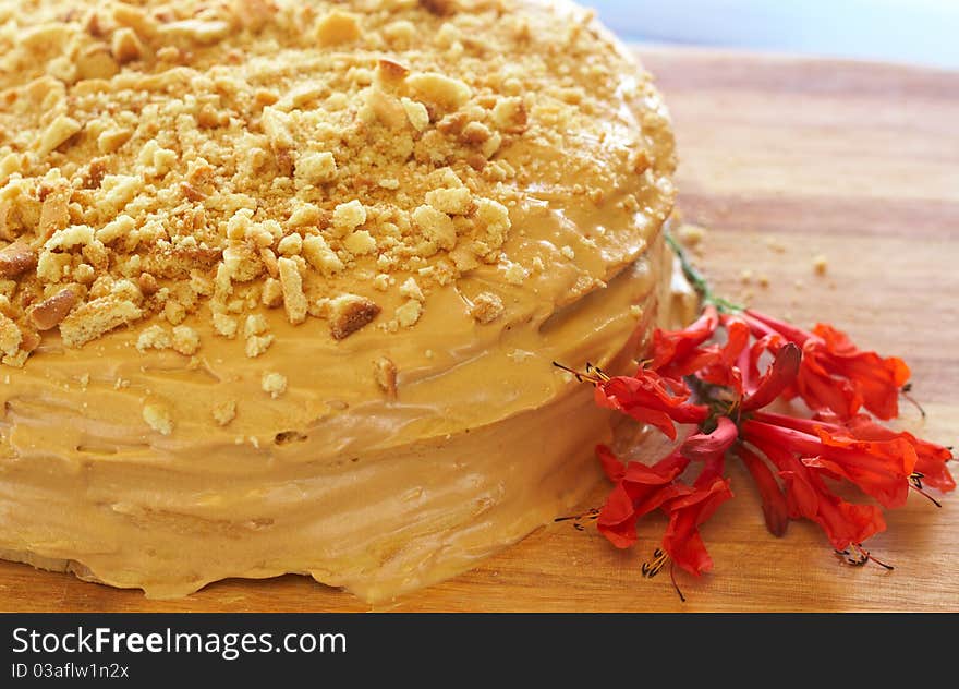 Caramel medovik cake made of honey and caramel cream, decorated with flowers