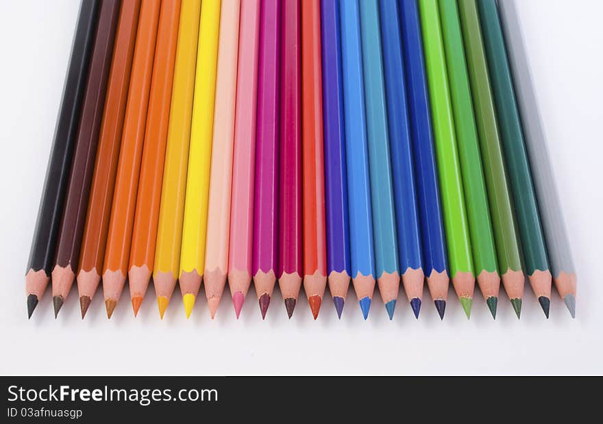 Close-up of colored pencils, top view, on white background. Close-up of colored pencils, top view, on white background