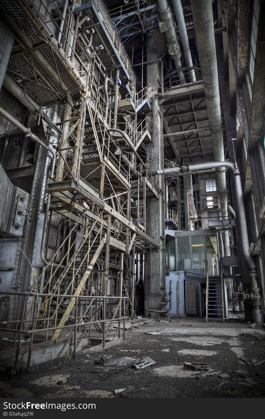 The interior of an old abandoned machine hall, with the control room in front and the staircase to reach the upper deck on the left. The interior of an old abandoned machine hall, with the control room in front and the staircase to reach the upper deck on the left.