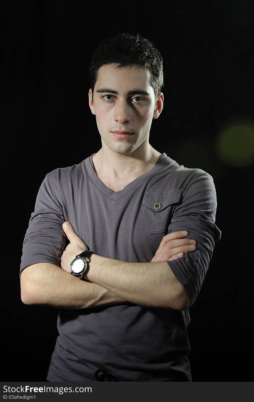 Portrait of young handsome man on dark background. Portrait of young handsome man on dark background