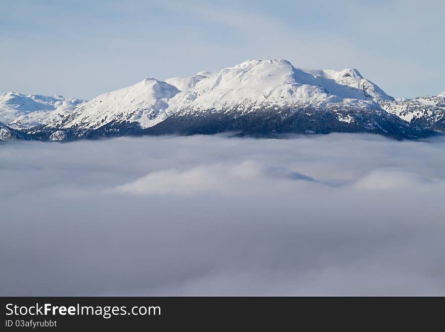 Mountain summits above the clouds in the area near Whistler. Mountain summits above the clouds in the area near Whistler