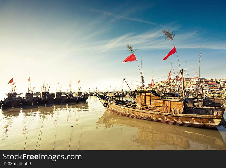 Fishermen berthed in coast in order. There are national flags hanging in backstay. Fishermen berthed in coast in order. There are national flags hanging in backstay.