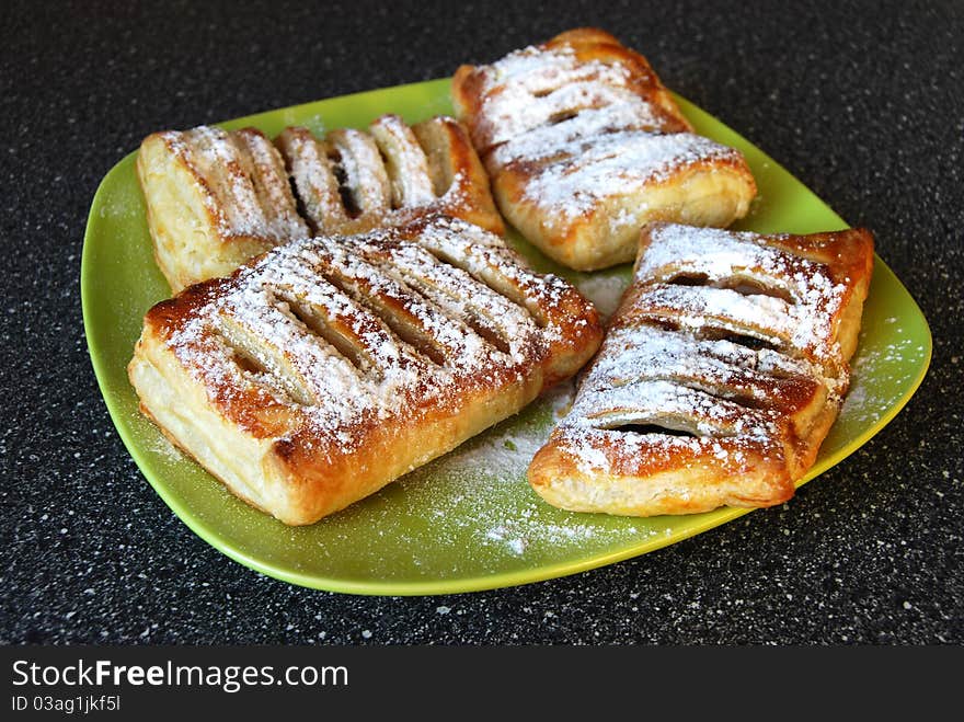 Fresh bread on green plate