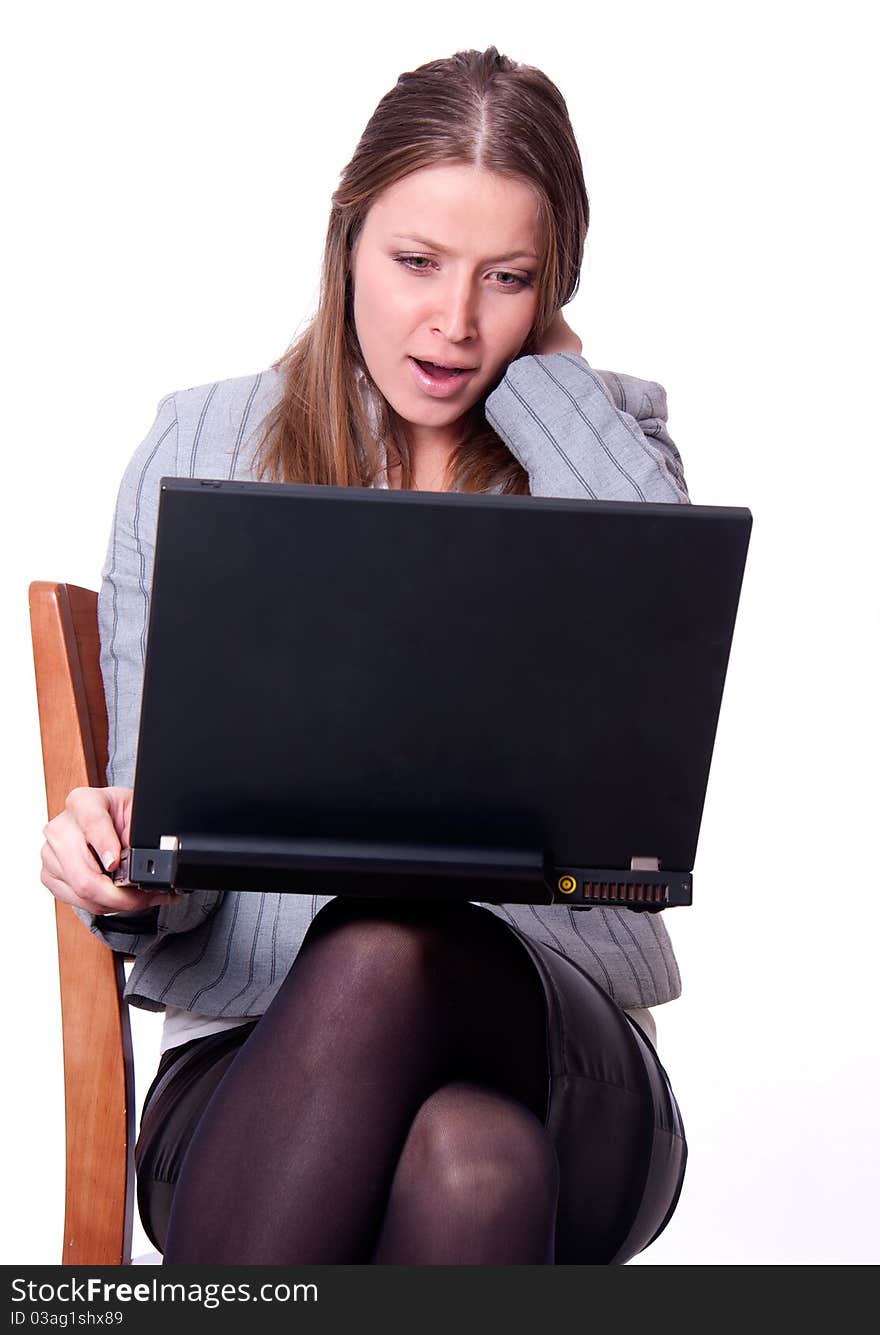 This is the studio portrait of young attractive woman with laptop excited and shouting. This is the studio portrait of young attractive woman with laptop excited and shouting.