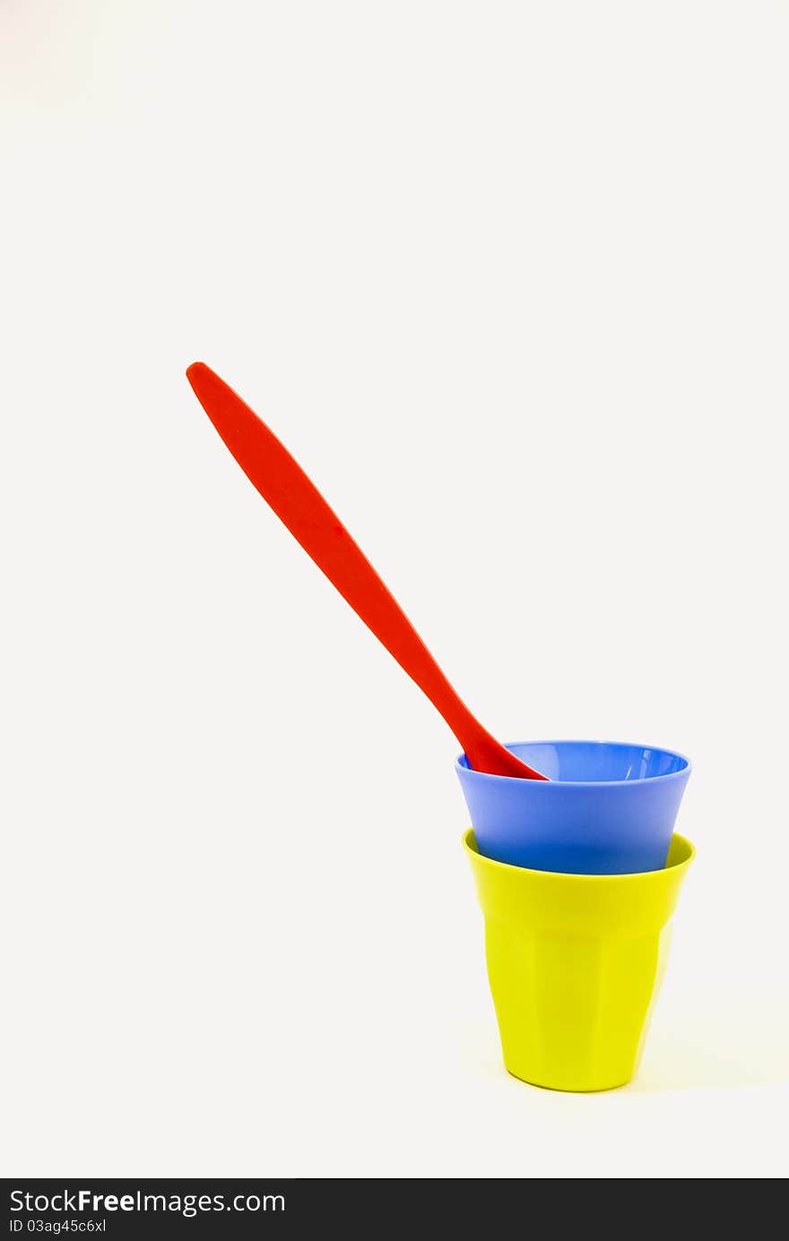 Colorful plastic plates and dishes isolated on a white background