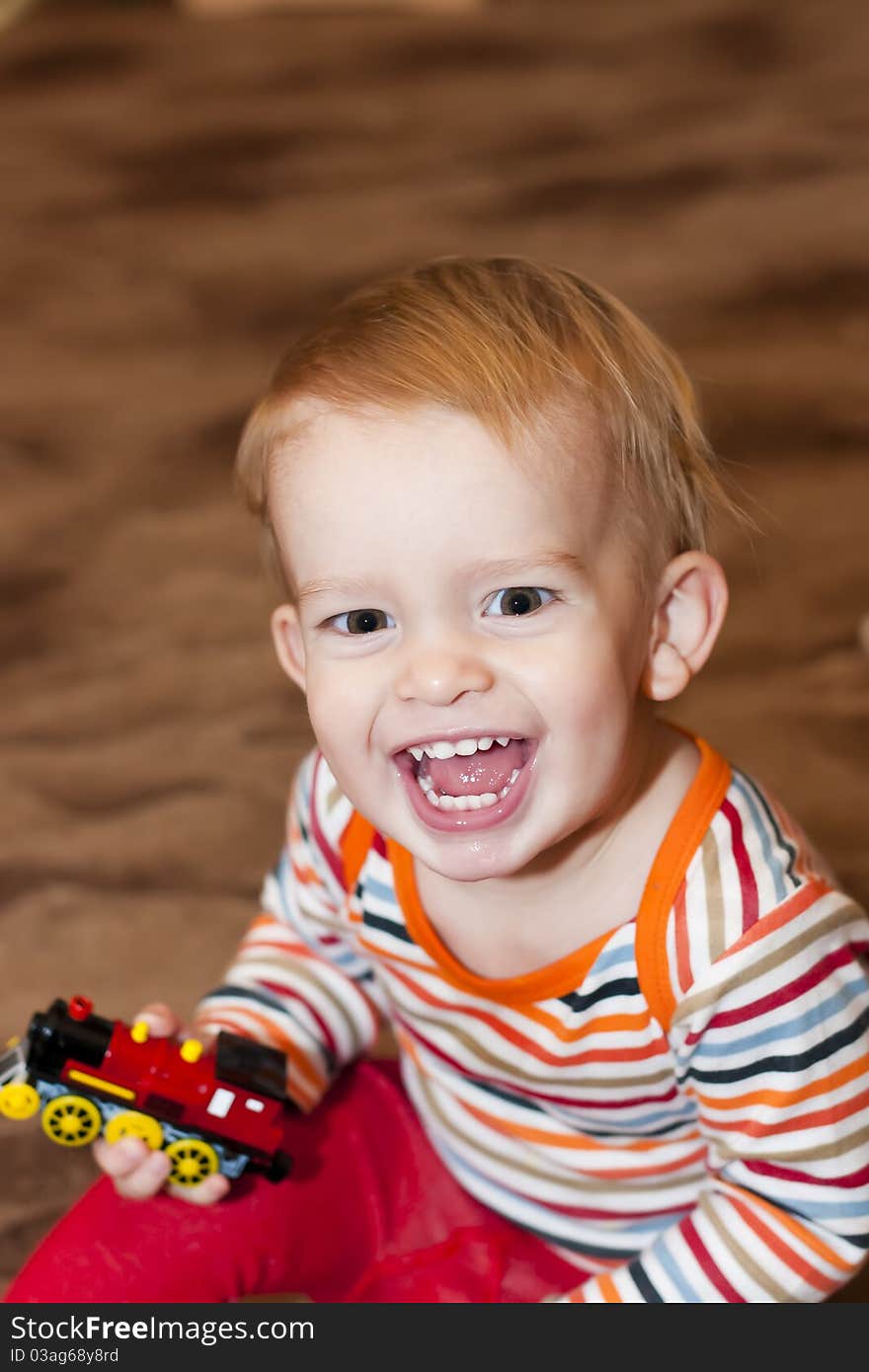 Happy young boy with toy