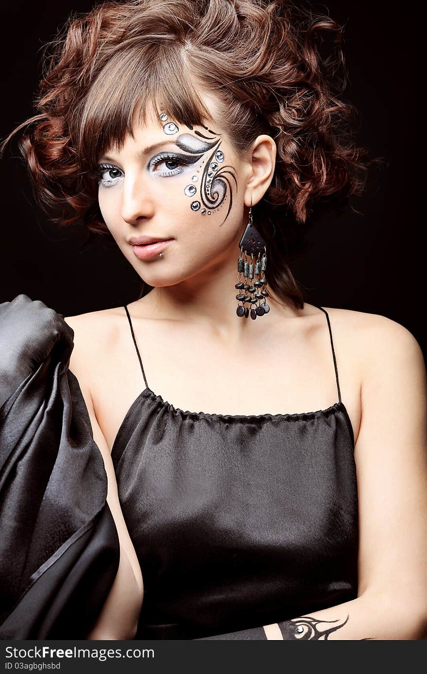 Beautiful fashionable woman in black dress. Studio shot. Beautiful fashionable woman in black dress. Studio shot.