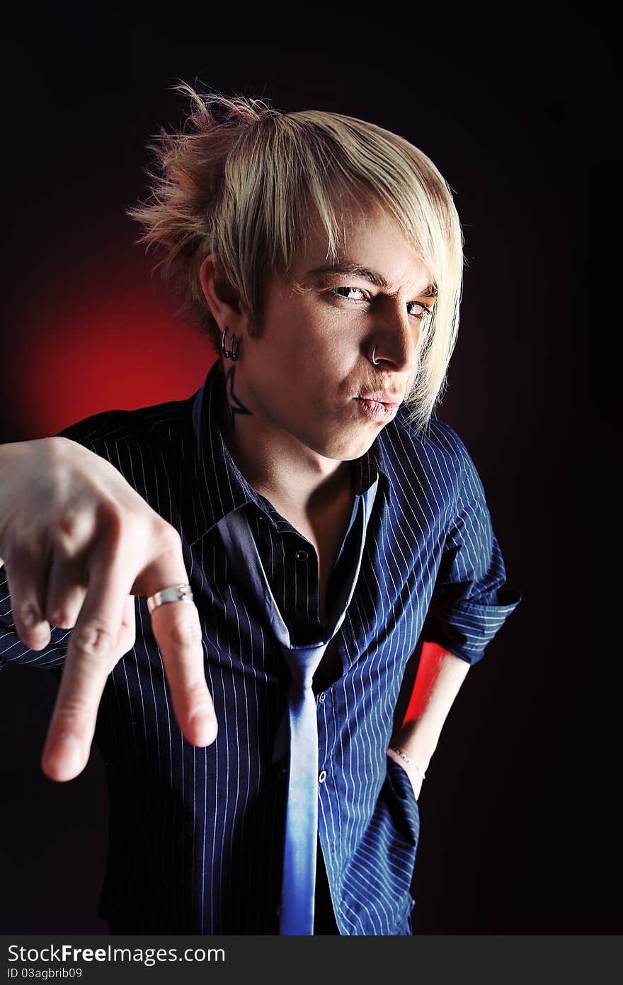 Portrait of an artistic young man. Studio shot over dark background. Portrait of an artistic young man. Studio shot over dark background.