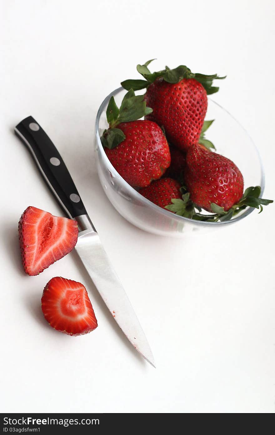 Strawberries being prepared to eat. Strawberries being prepared to eat