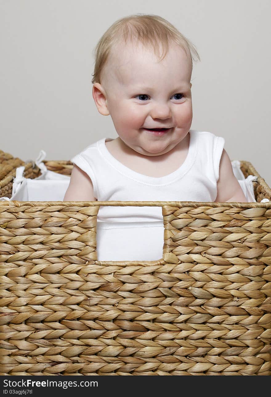 Cute baby boy playing in basket. Cute baby boy playing in basket