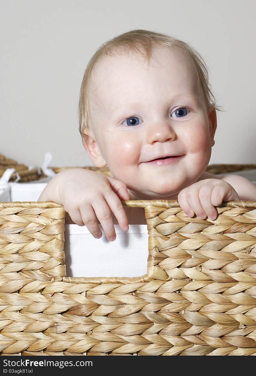 Cute baby boy playing in basket. Cute baby boy playing in basket