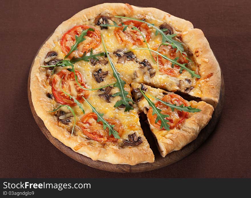 Fresh baked pizza with mushroom, tomatoes and rucola. Fresh baked pizza with mushroom, tomatoes and rucola