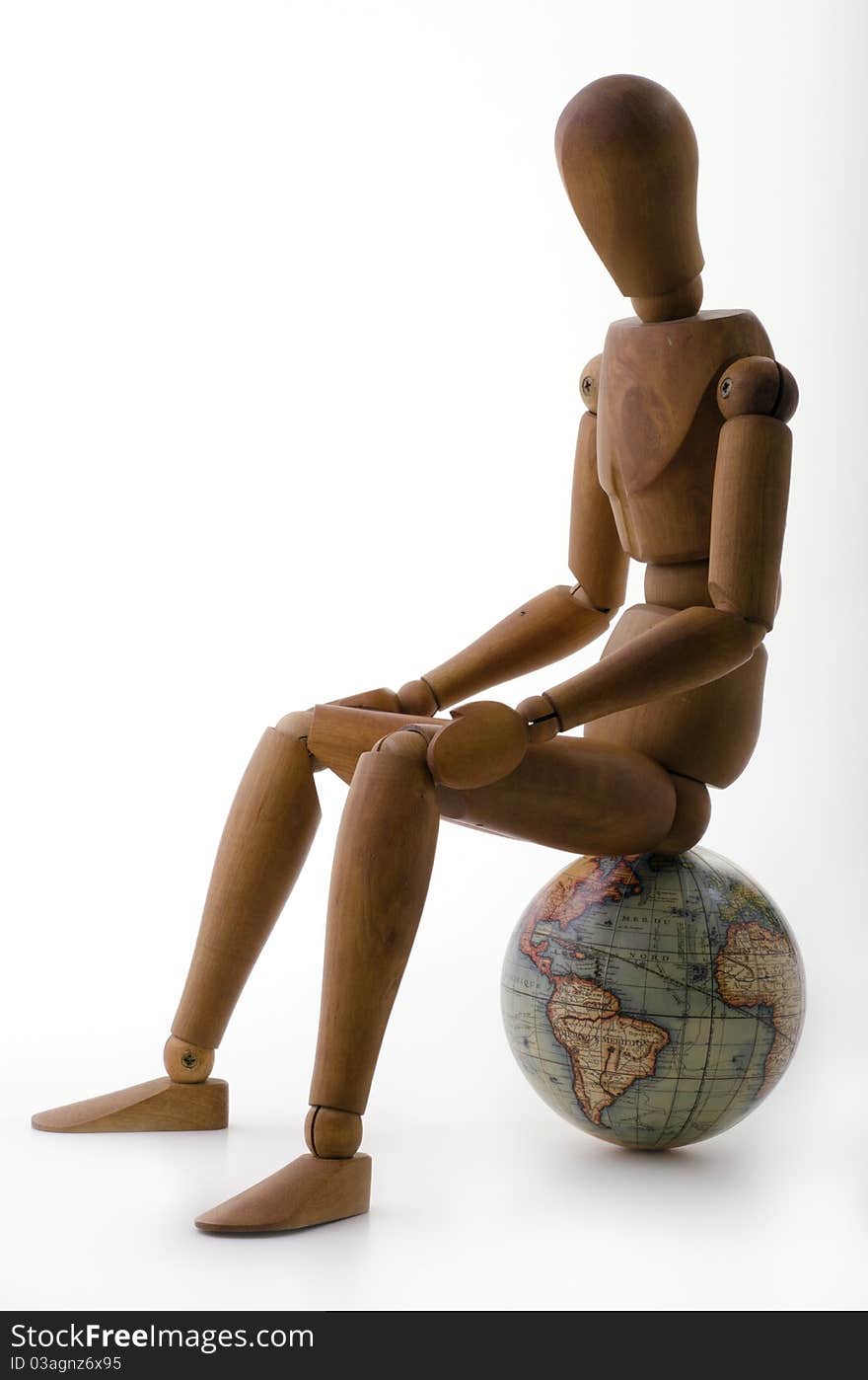 Dummy sitting on a globe. Dummy sitting on a globe