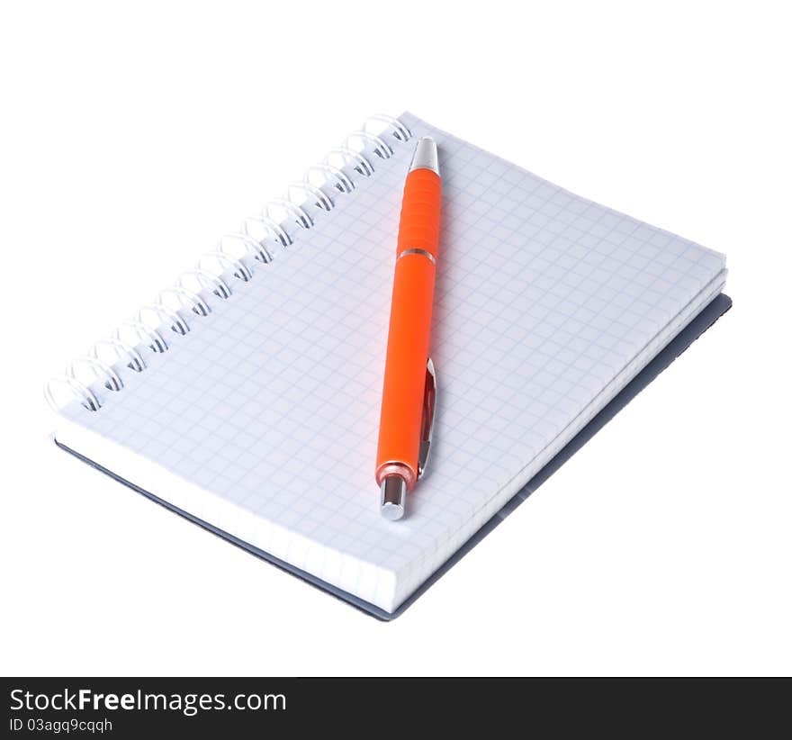 Orange pen and notebook on white background close-up (isolated). Orange pen and notebook on white background close-up (isolated).