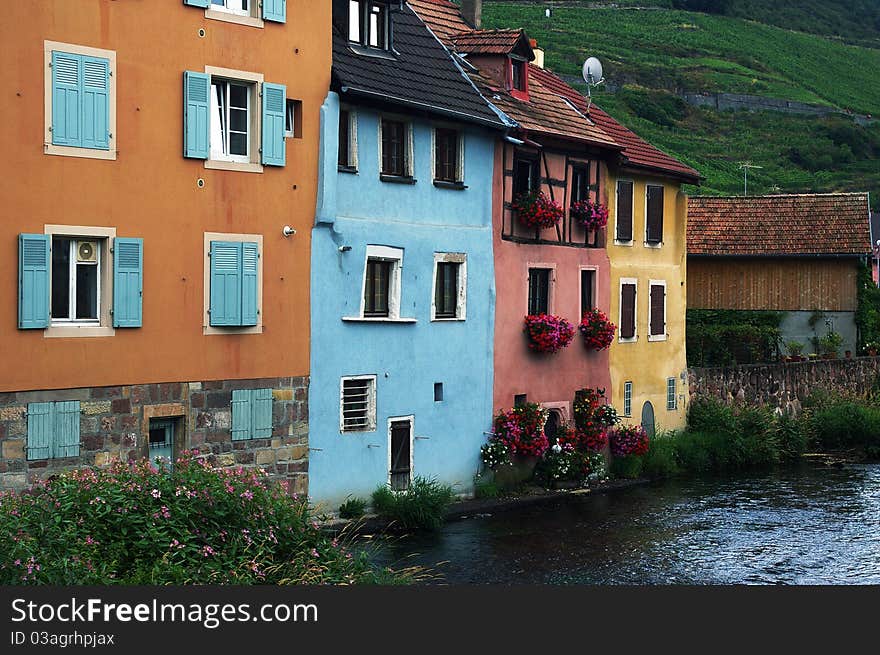 Typical Alsatian colorful houses  by the river, France.