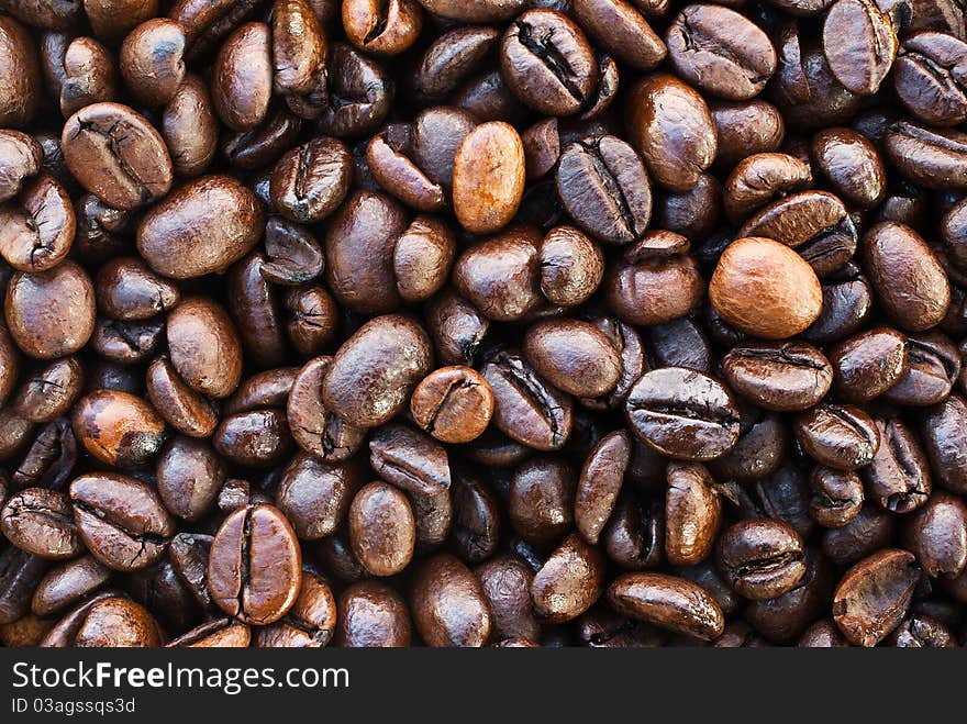 Shiny textured dark brown coffee beans