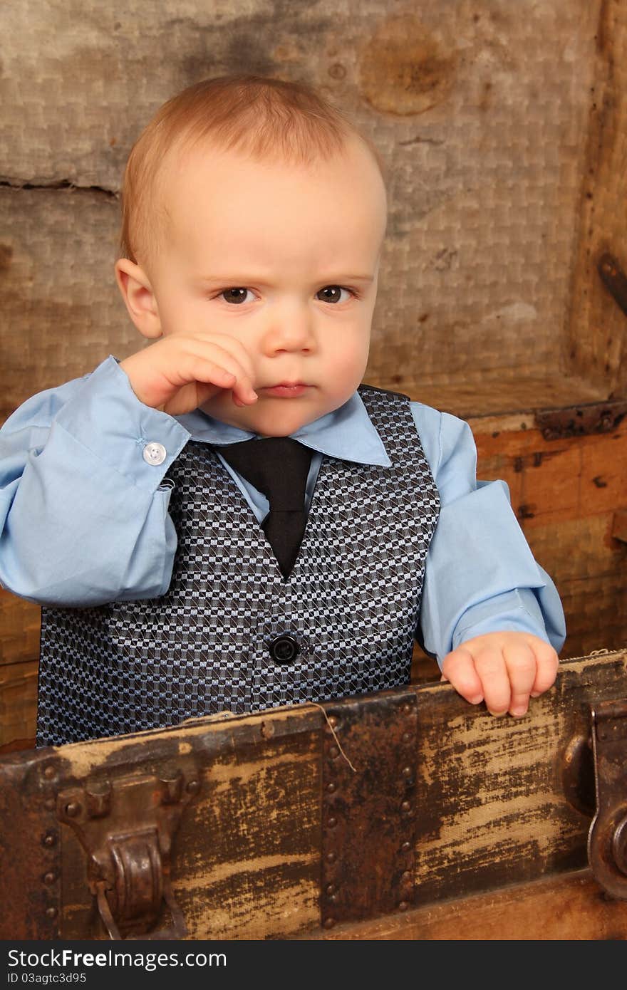 Baby boy playing inside an antique trunk. Baby boy playing inside an antique trunk