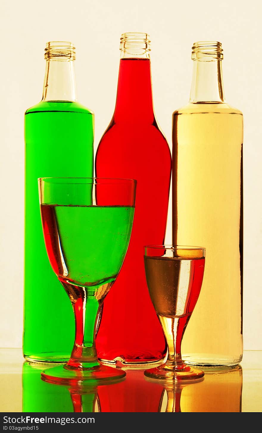 Lemonade in glasses and bottles of red, green, yellow color