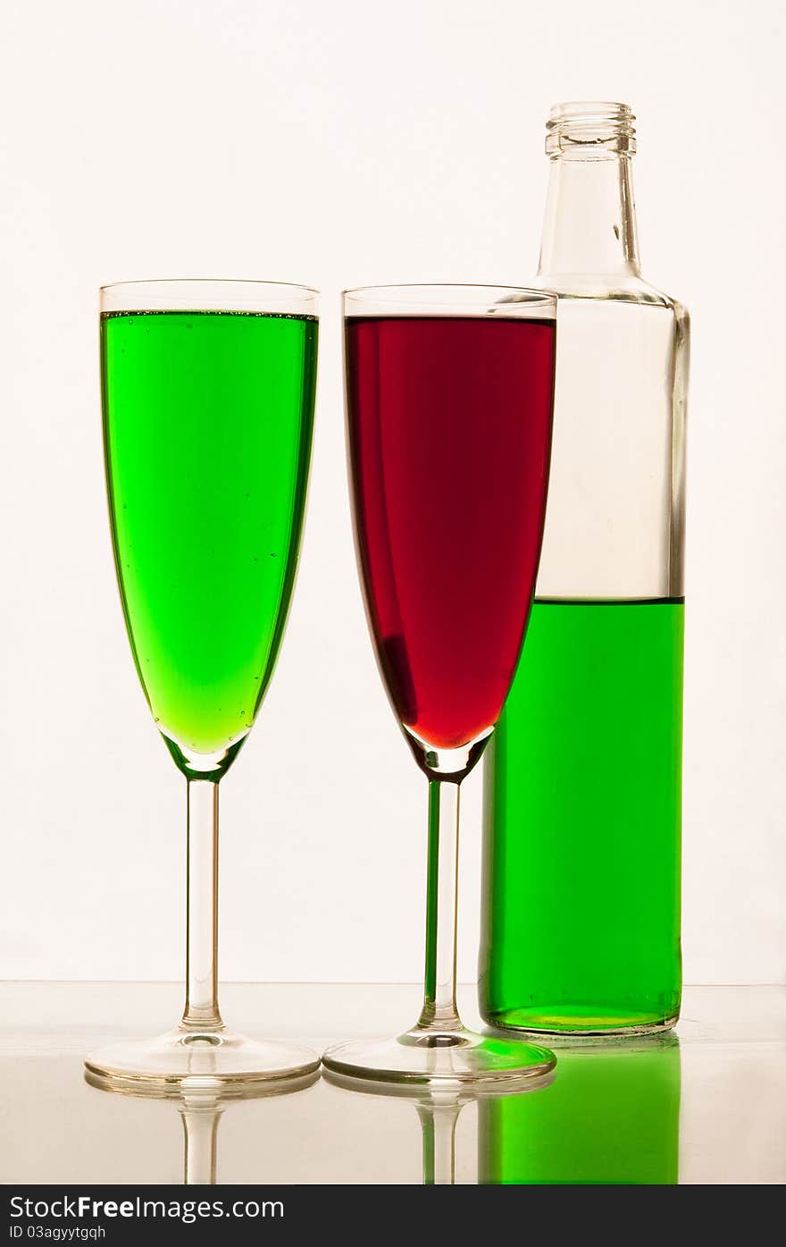 Lemonade in glasses and bottles of green, red color