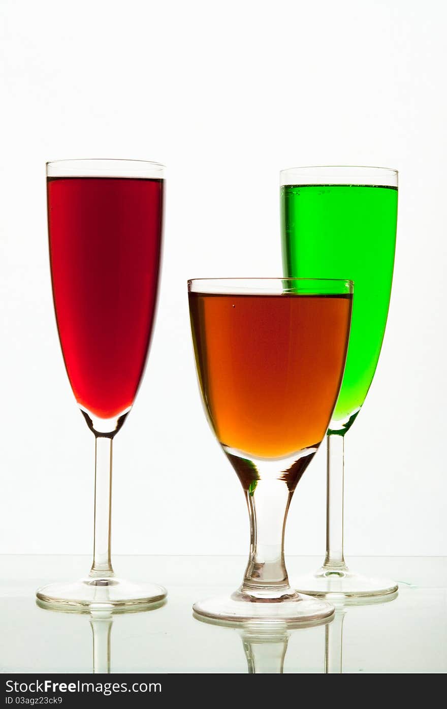 Lemonade in glasses and bottles of green, red color