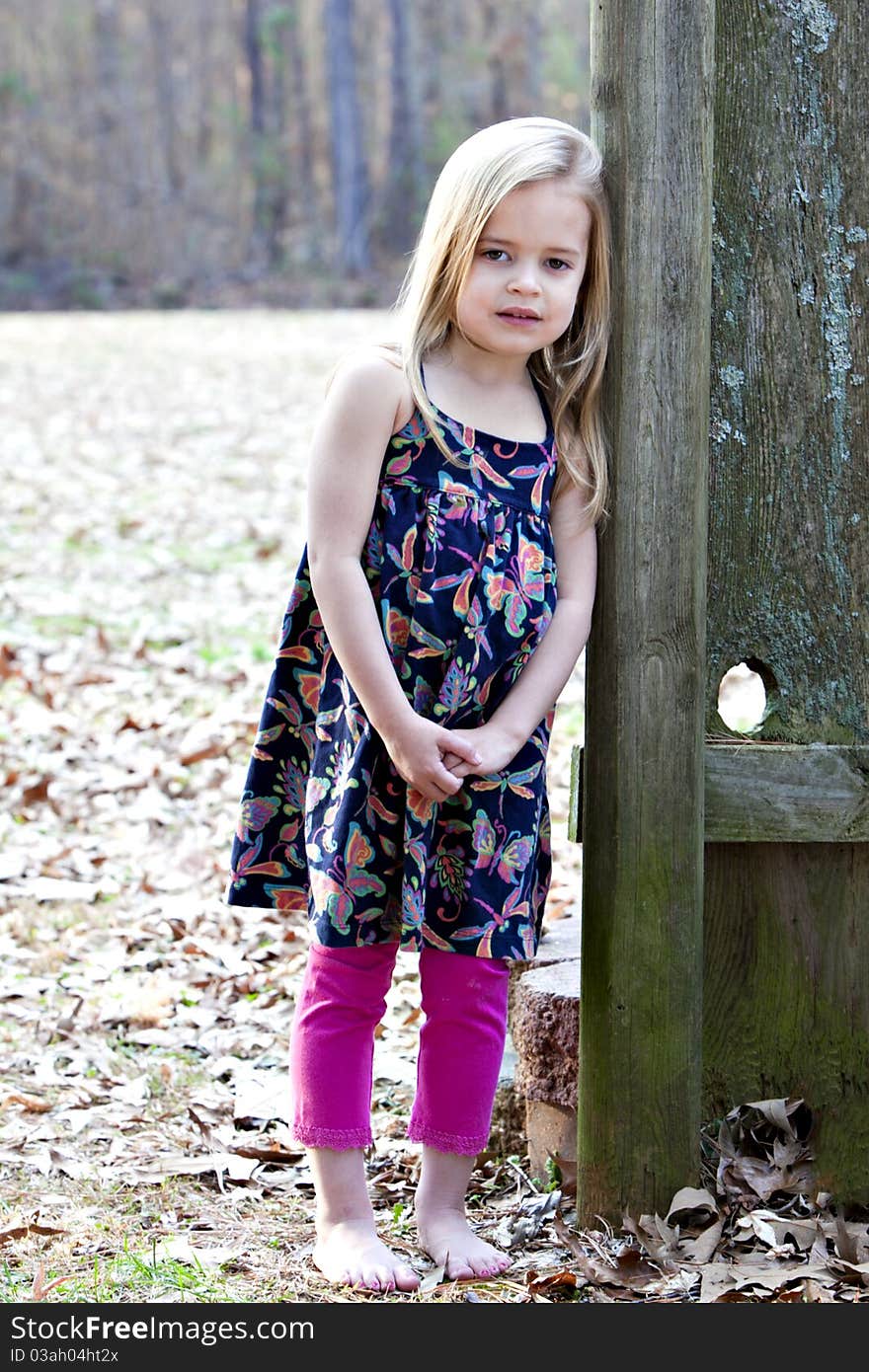 Beautiful little four year old girl outdoors in beautiful print top with pink leggings. Beautiful little four year old girl outdoors in beautiful print top with pink leggings