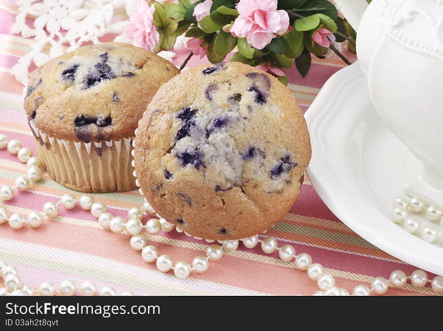 Delicious blueberry muffins with a feminine tea party setting