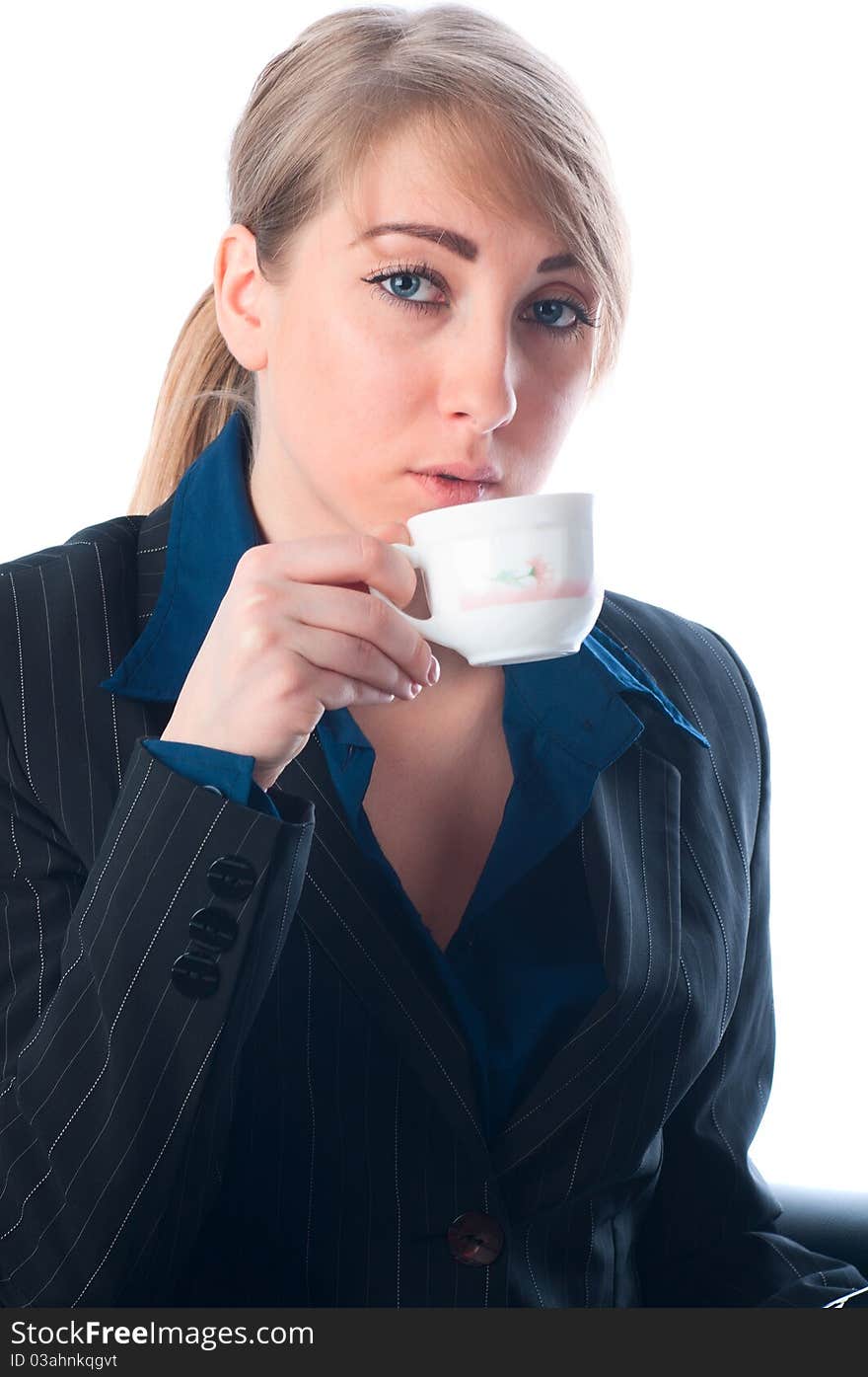 The businesswoman on a break drinks coffee in office