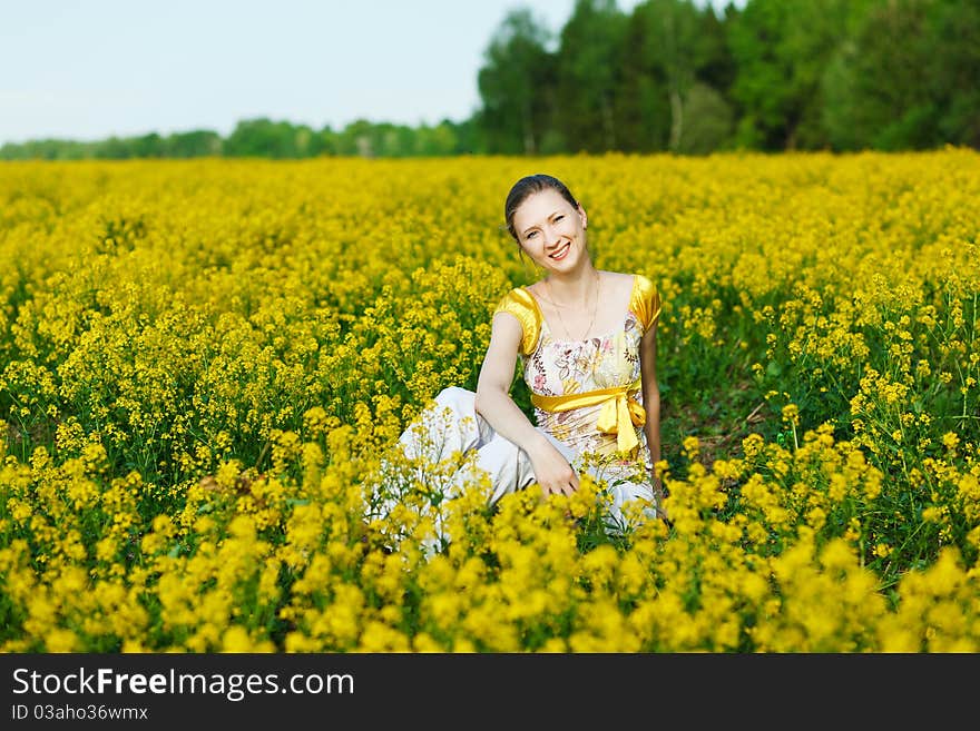 Happy woman on yellow field